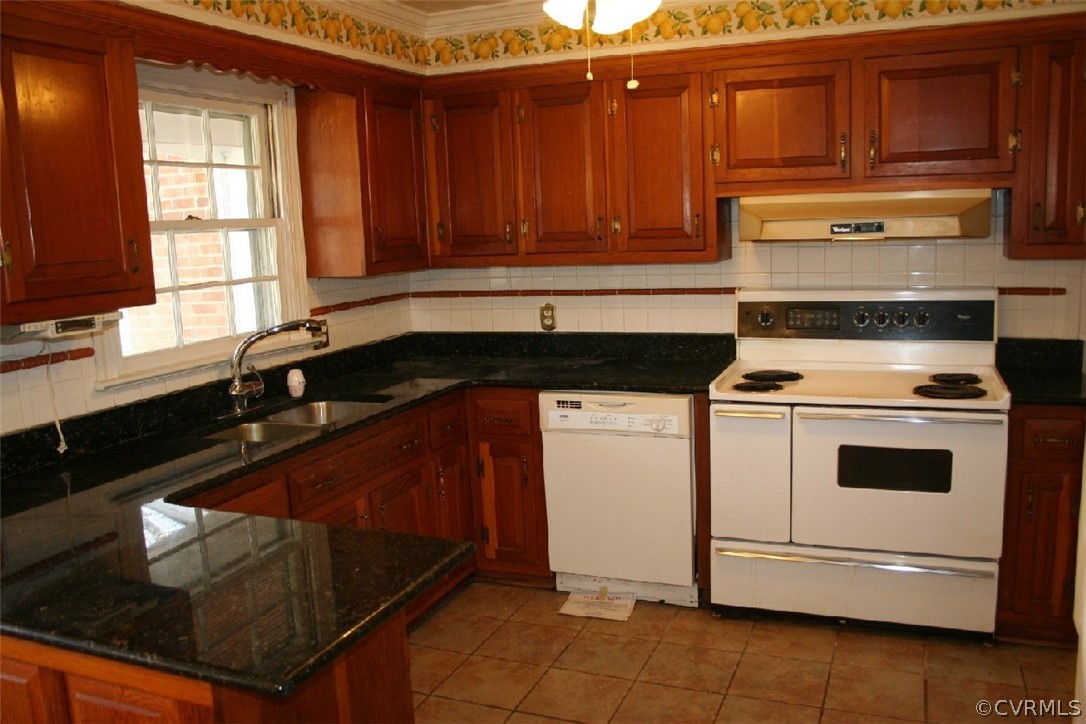 12185 Hanover Courthouse Road Hanover, VA 23069 - Photo 3 of 24 a kitchen with granite countertop wooden cabinets and white appliances