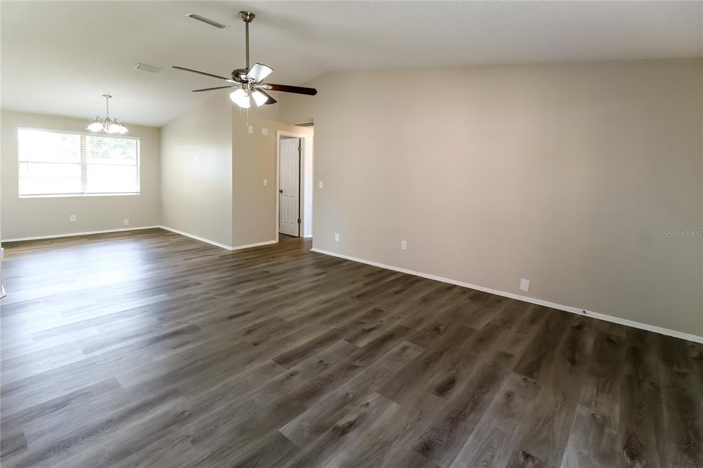 4560 Chamber Court Spring Hill, FL 34609 - Photo 5 of 16 wooden floor in an empty room with a window