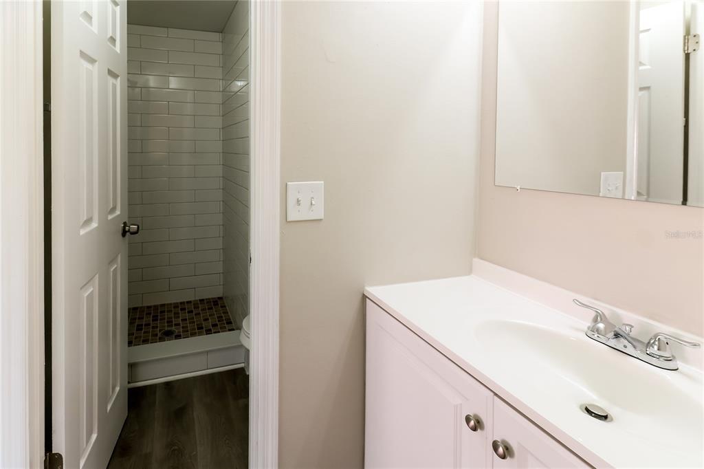 4560 Chamber Court Spring Hill, FL 34609 - Photo 9 of 16 a bathroom with a sink and a mirror