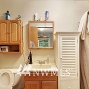1240 Kenoyer Drive Bellingham, WA 98229 - Photo 15 of 22 a bathroom with a sink a toilet and a mirror