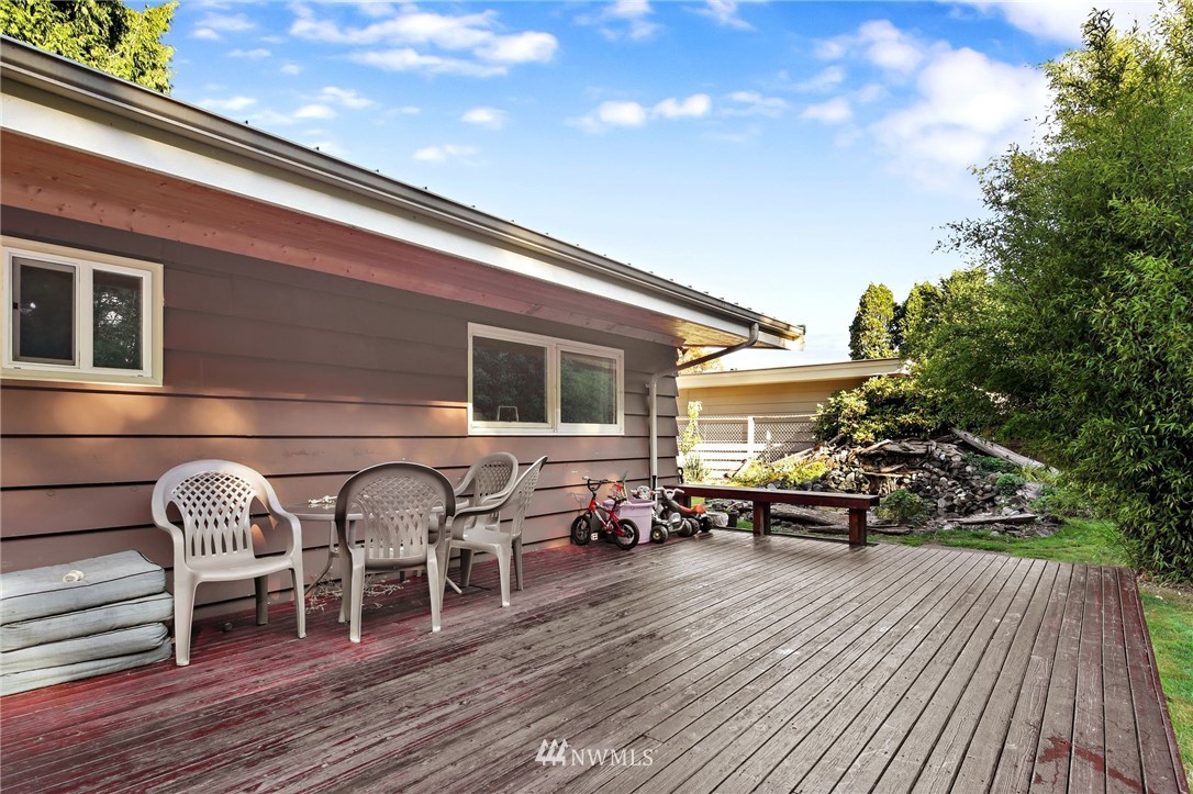 1240 Kenoyer Drive Bellingham, WA 98229 - Photo 16 of 22 a view of a patio with table and chairs with wooden floor and fence