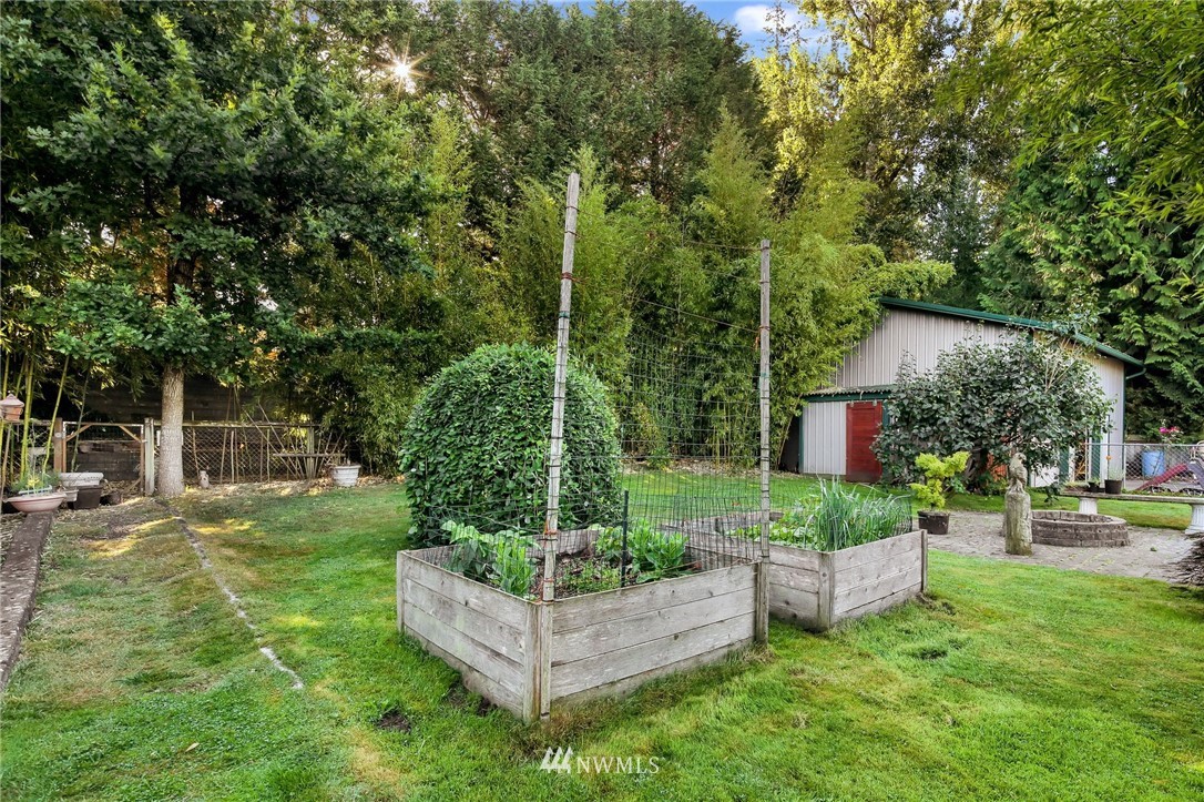 1240 Kenoyer Drive Bellingham, WA 98229 - Photo 19 of 22 a view of a chair and table in backyard of the house