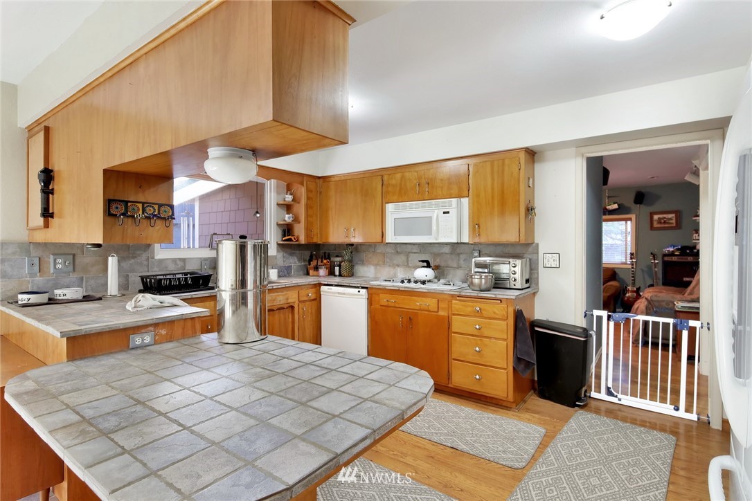1240 Kenoyer Drive Bellingham, WA 98229 - Photo 3 of 22 a large kitchen with cabinets and wooden floor
