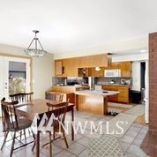1240 Kenoyer Drive Bellingham, WA 98229 - Photo 6 of 22 a living room with couches and kitchen view with wooden floor