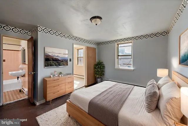 a bedroom with a bed and a large window