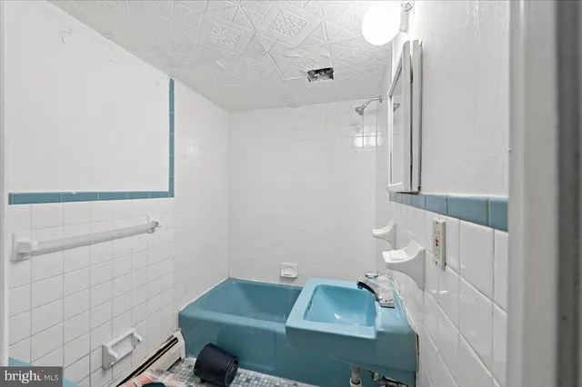 a front view of a house with a yard covered with snow and trees