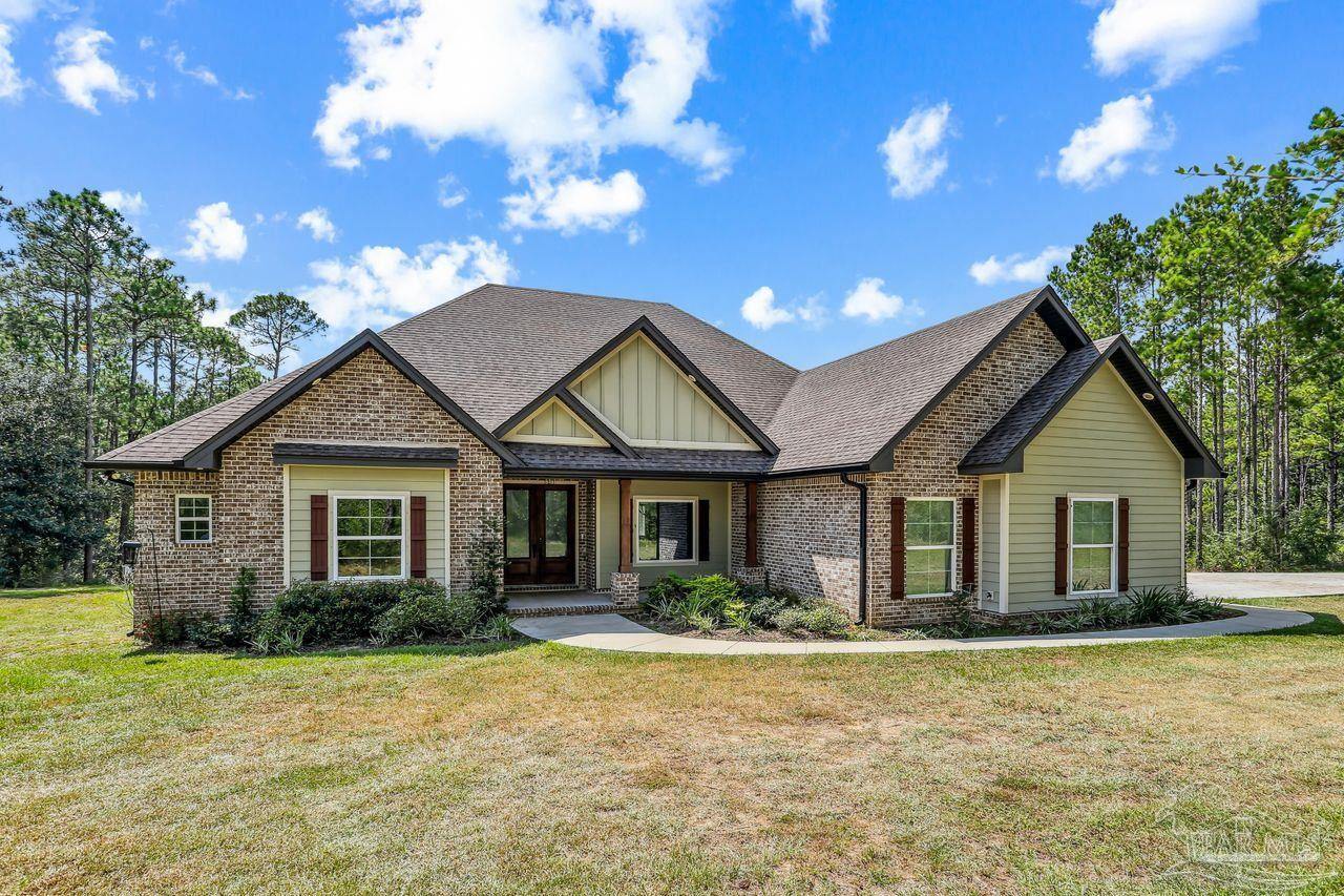 a front view of house with yard and green space