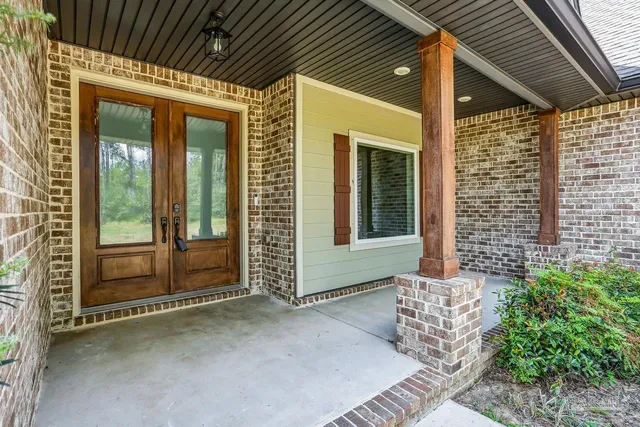 a view of an empty room with a fireplace and a window