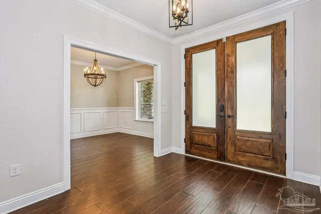 a kitchen with granite countertop white cabinets and stainless steel appliances
