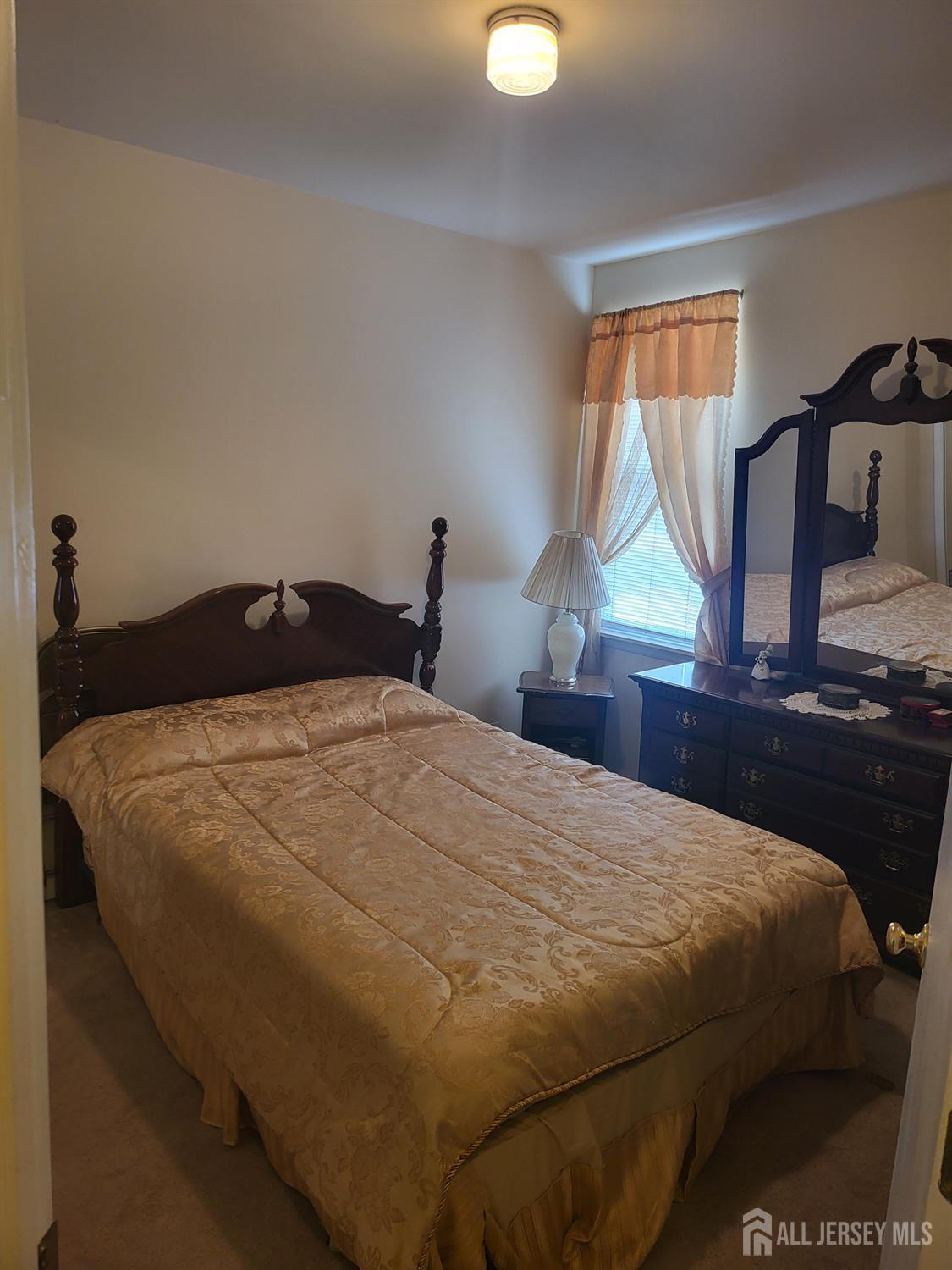 54 State Street Perth Amboy, NJ 08861 - Photo 12 of 35 a bedroom with a bed and window