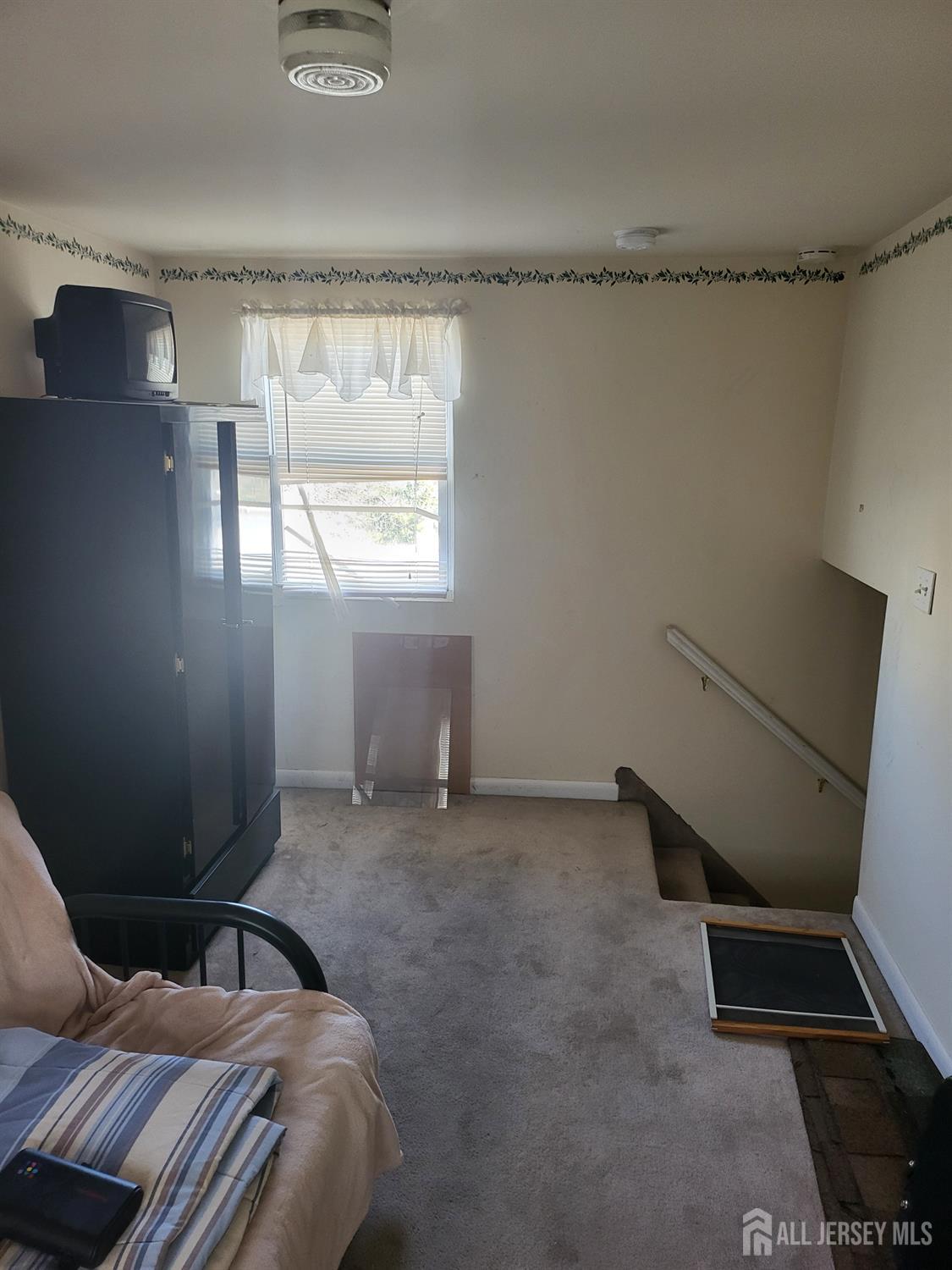 54 State Street Perth Amboy, NJ 08861 - Photo 17 of 35 a bedroom with a bed and a window