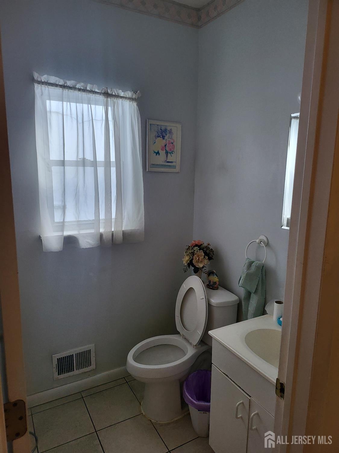 54 State Street Perth Amboy, NJ 08861 - Photo 5 of 35 a bathroom with a toilet sink and mirror