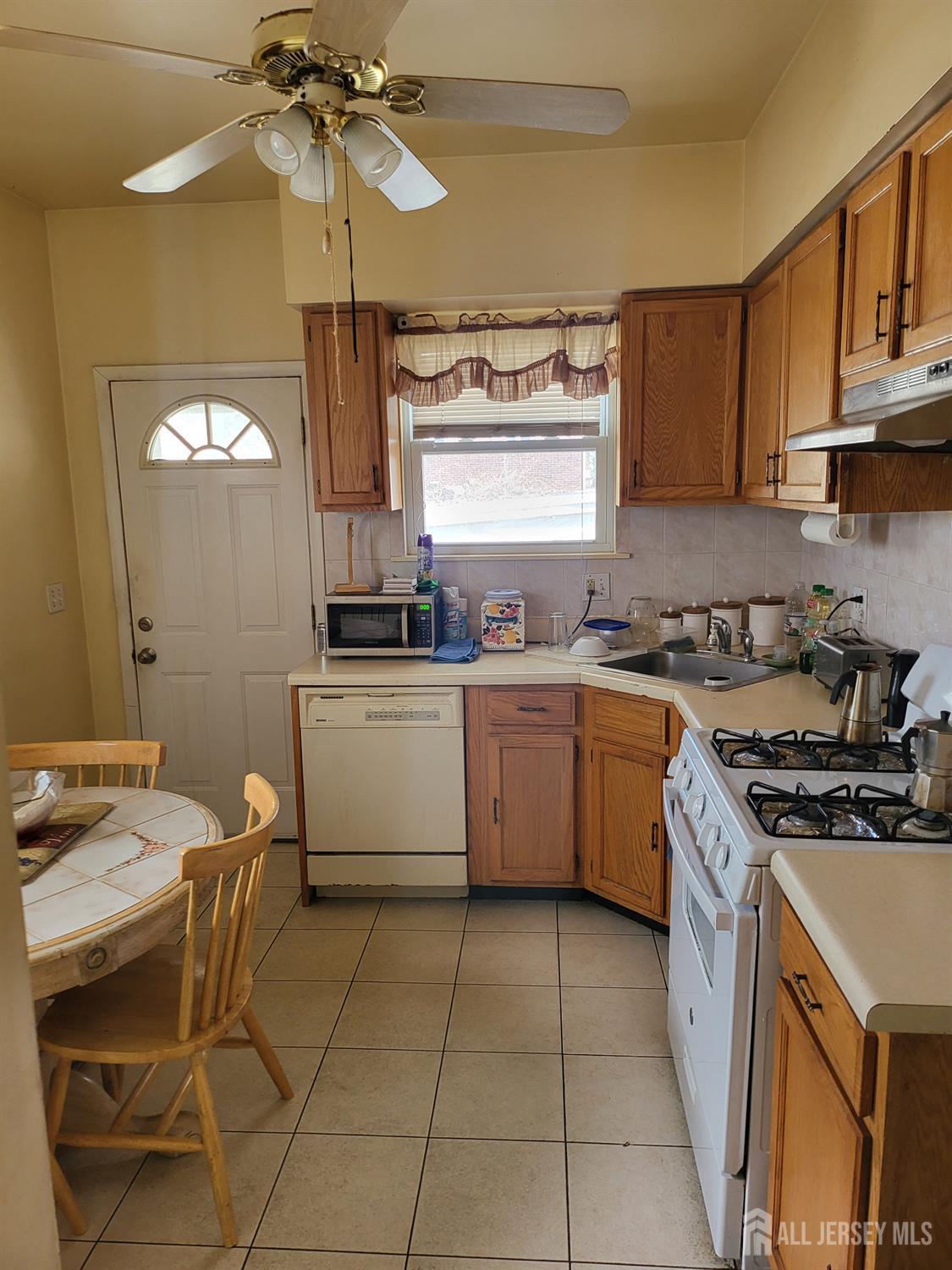 54 State Street Perth Amboy, NJ 08861 - Photo 6 of 35 a kitchen with a stove cabinets and a window