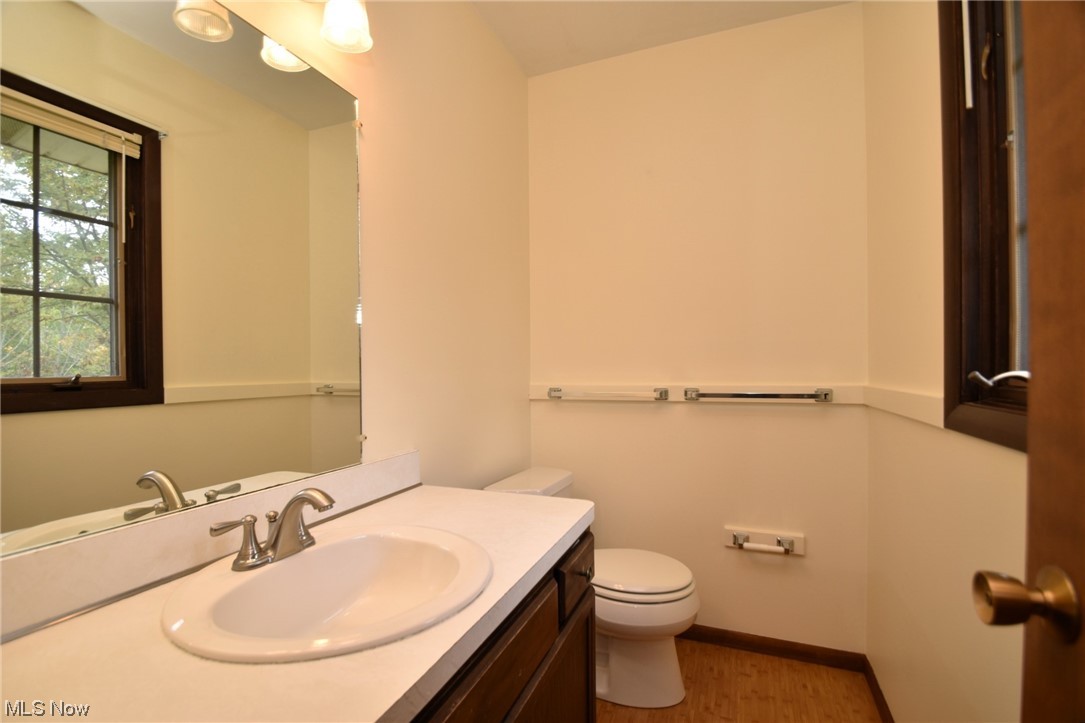 9748 Mulberry Road Chardon, OH 44024 - Photo 3 of 10 Master Bathroom with vanity , light hardwood
floors, and mirror