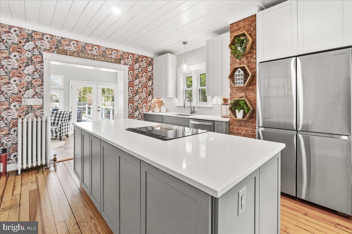 403 Wilson Place Frederick, MD 21702 - Photo 12 of 63 a kitchen with a refrigerator and a table