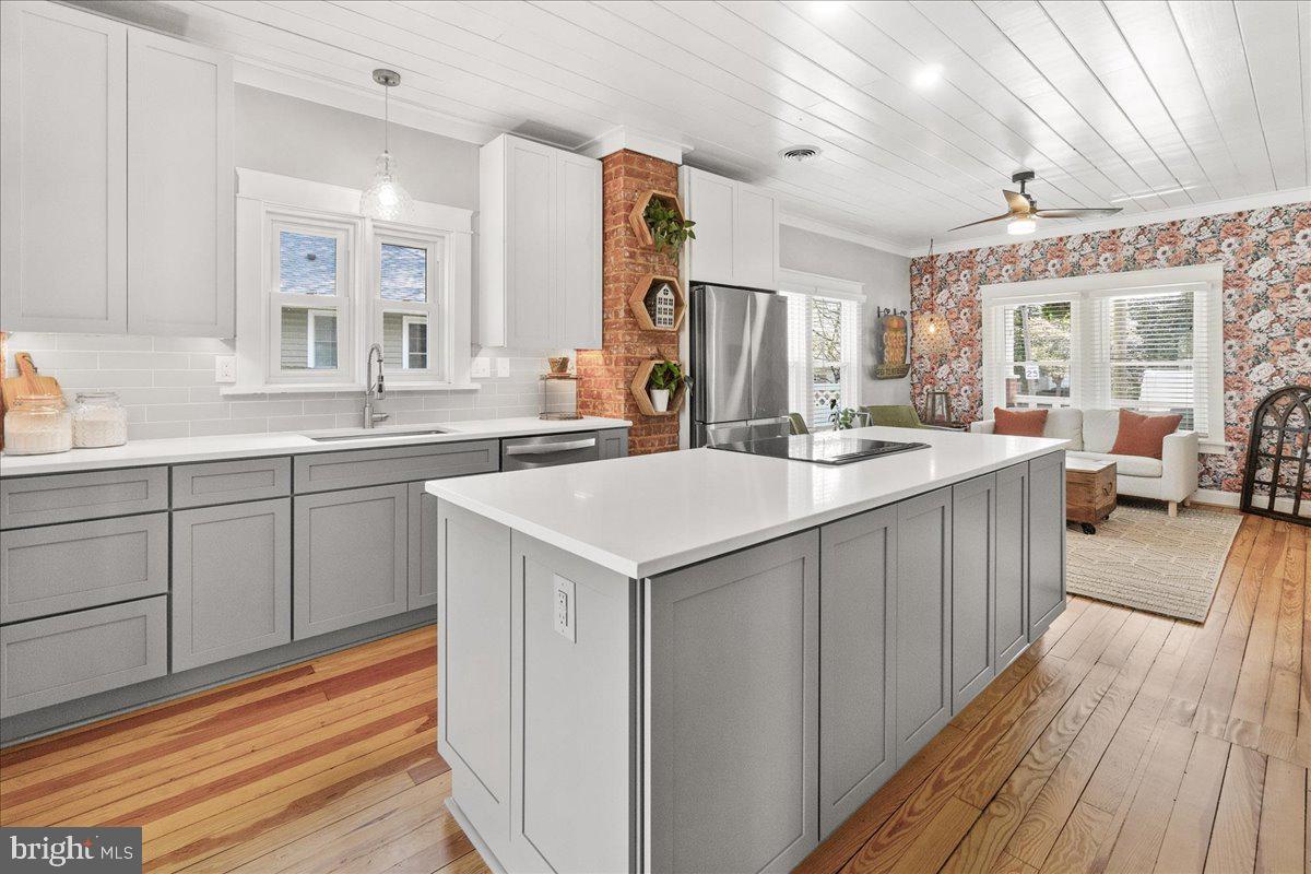 403 Wilson Place Frederick, MD 21702 - Photo 13 of 63 a kitchen with a sink stove and cabinets