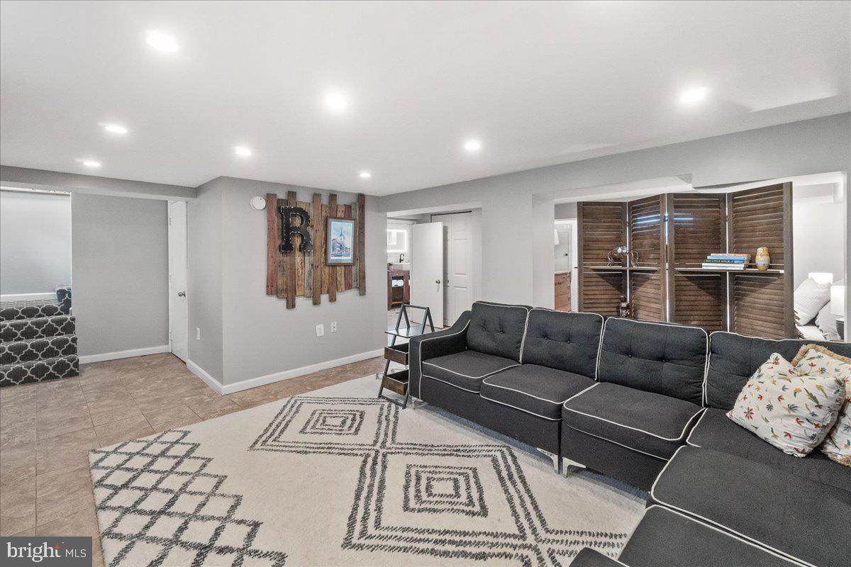 403 Wilson Place Frederick, MD 21702 - Photo 29 of 63 a living room with furniture and a rug