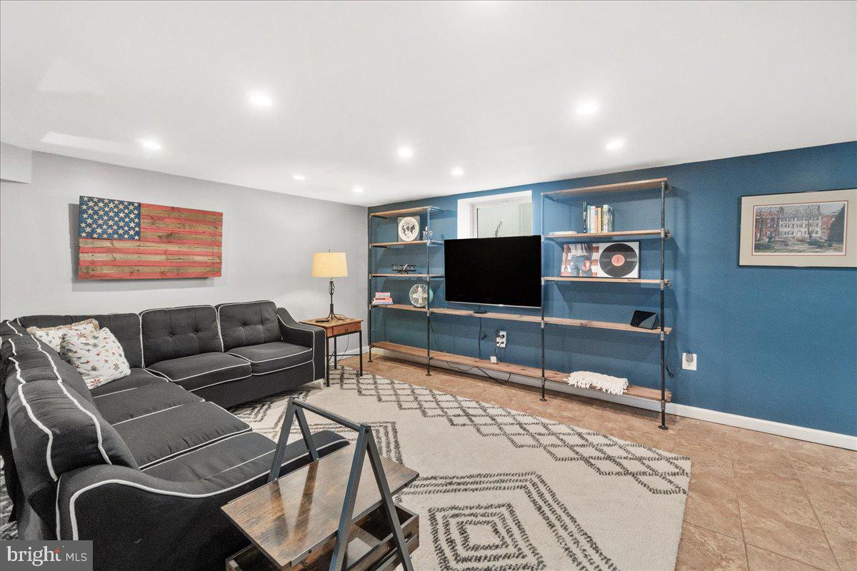 403 Wilson Place Frederick, MD 21702 - Photo 30 of 63 a living room with furniture and a flat screen tv