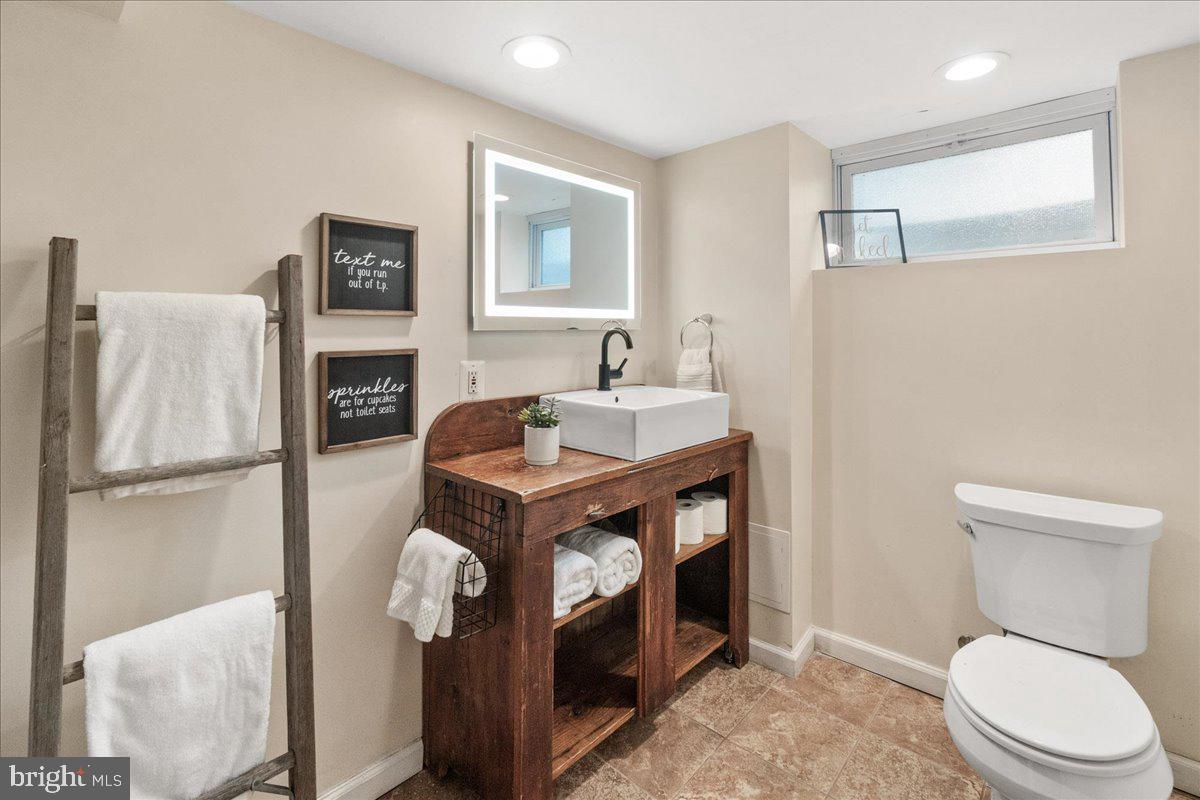 403 Wilson Place Frederick, MD 21702 - Photo 33 of 63 a bathroom with a toilet a sink and mirror