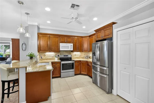 a kitchen with refrigerator cabinets and stainless steel appliances
