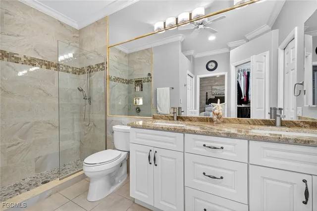 a bathroom with a granite countertop sink a toilet and a shower