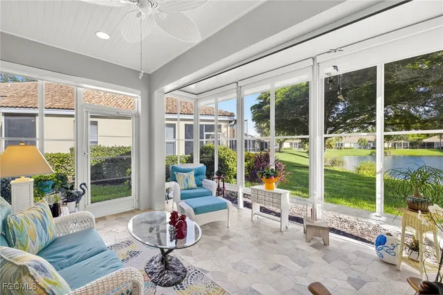 a living room with furniture and large windows