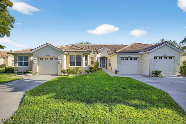 a view of a yard in front of a house with green space