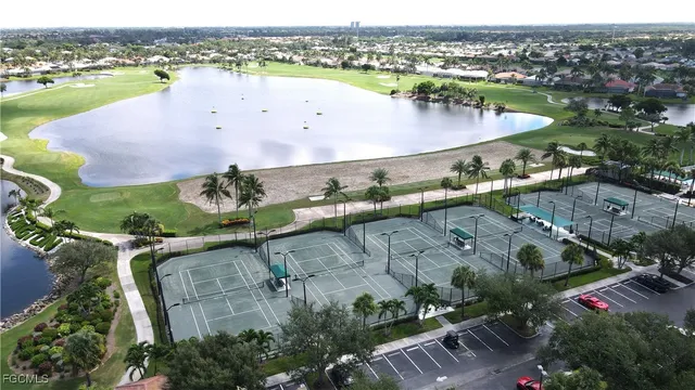 an aerial view of house with yard swimming pool and ocean view