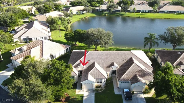 an aerial view of house with yard and lake view