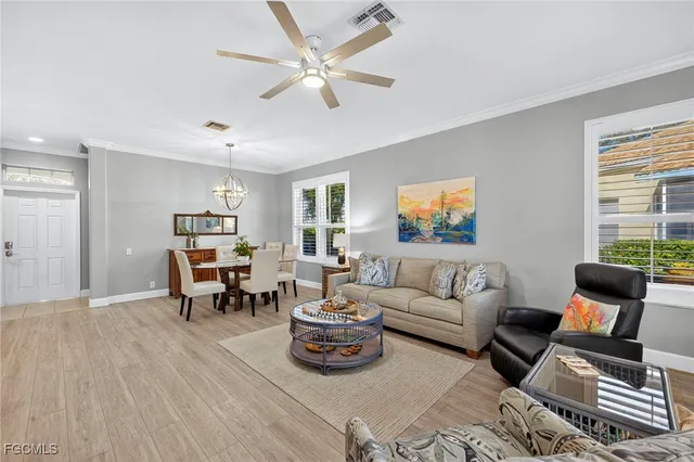 a living room with furniture a wooden floor and a window