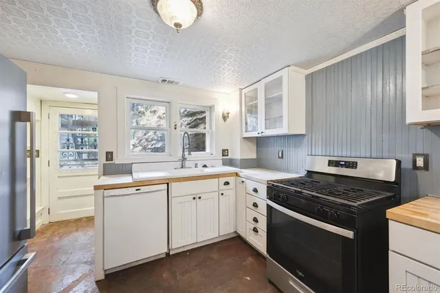 a kitchen with stainless steel appliances granite countertop a stove and a sink