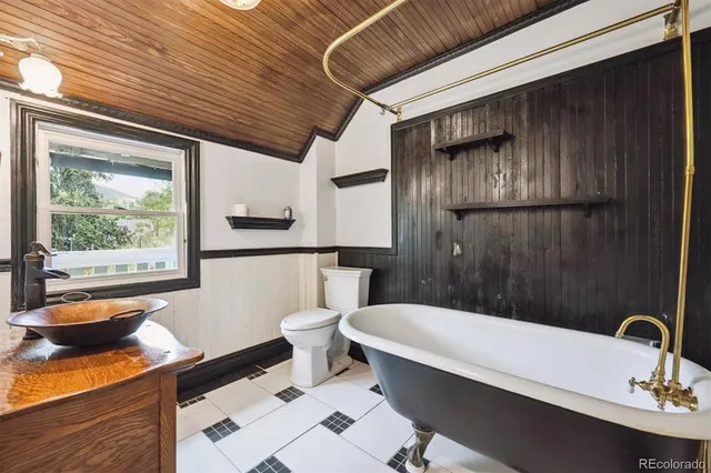 a bathroom with a sink a toilet and bathtub