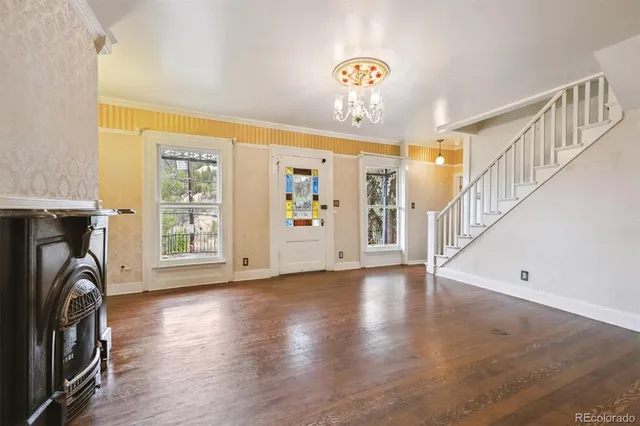 a view of a hallway with entryway and wooden floor