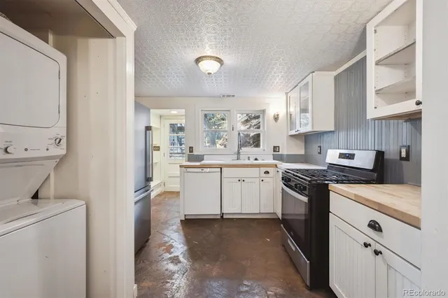 a kitchen with white cabinets and white appliances