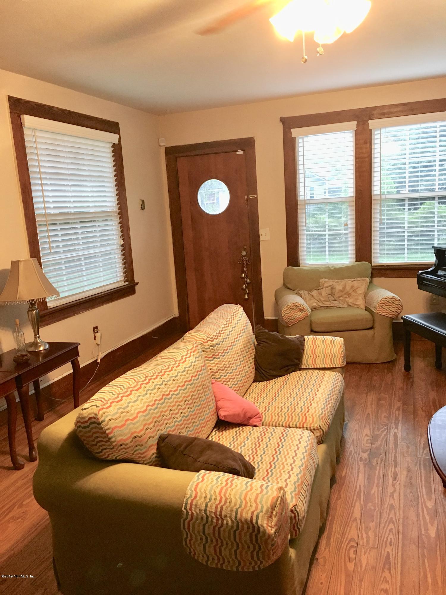 11628 Flynn Road Jacksonville, FL 32223 - Photo 4 of 5 a living room with furniture and a large window
