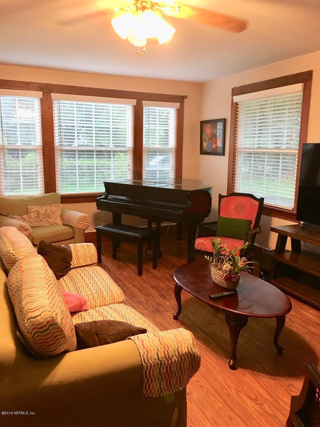11628 Flynn Road Jacksonville, FL 32223 - Photo 5 of 5 a living room with furniture and a floor to ceiling window