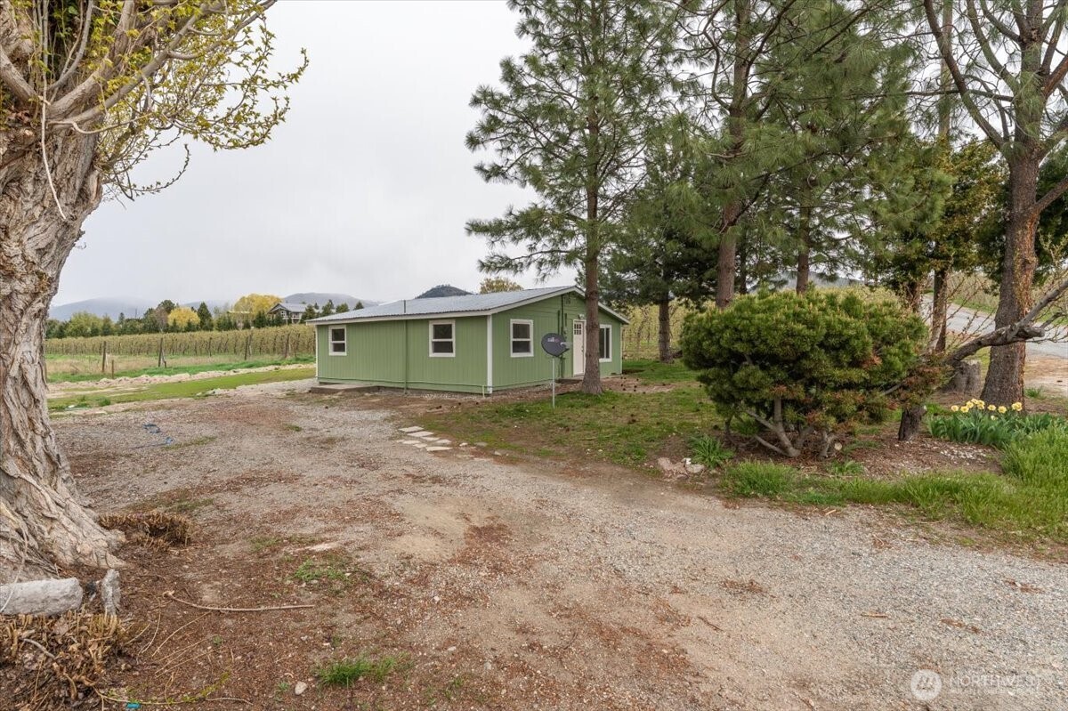 293 Barkley Road Manson, WA 98831 - Photo 36 of 40 a view of an house with backyard space and a tree
