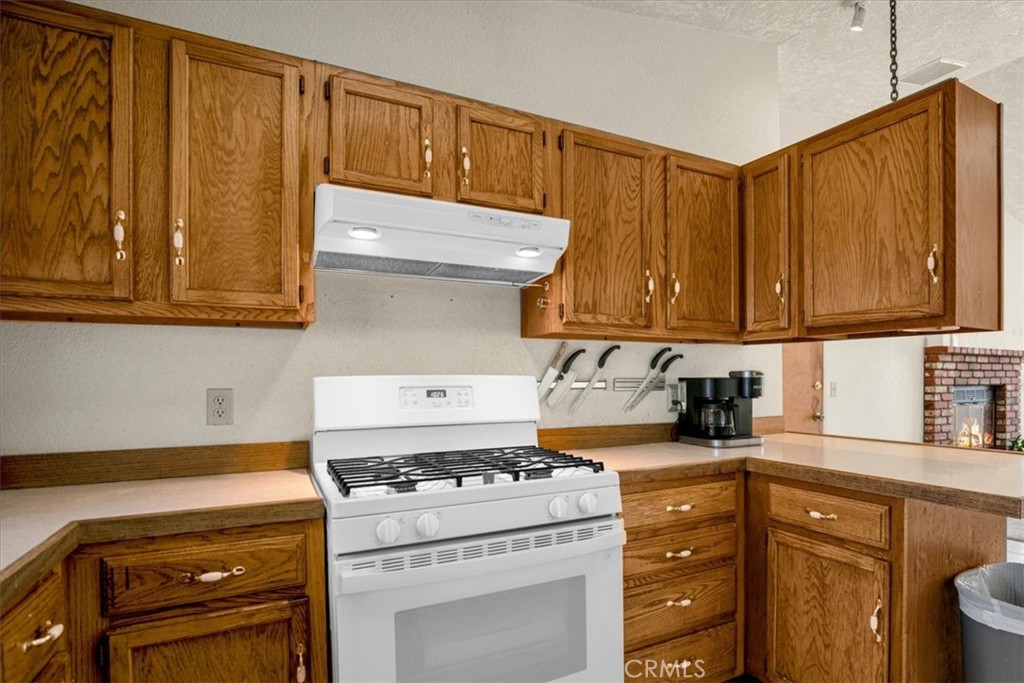 72775 2 Mile Road Twentynine Palms, CA 92277 - Photo 13 of 55 a kitchen with granite countertop cabinets and steel stove top oven