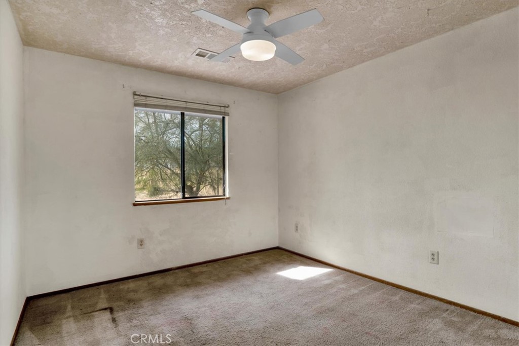 72775 2 Mile Road Twentynine Palms, CA 92277 - Photo 15 of 55 an empty room with a window and ceiling fan