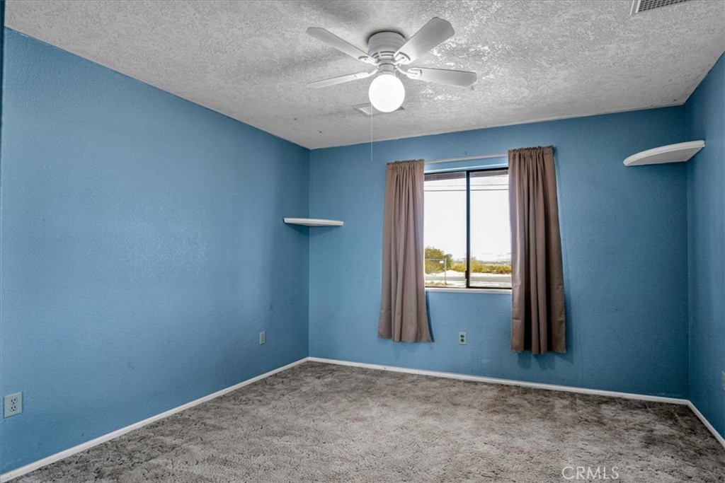 72775 2 Mile Road Twentynine Palms, CA 92277 - Photo 17 of 55 an empty room with windows and fan