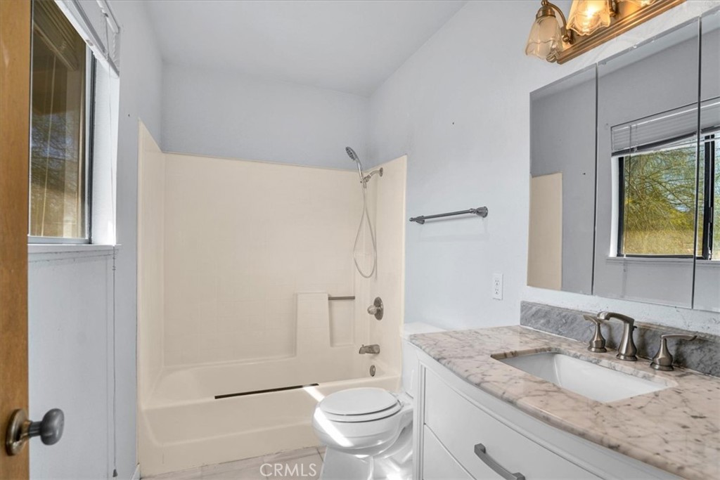 72775 2 Mile Road Twentynine Palms, CA 92277 - Photo 24 of 55 a bathroom with a granite countertop sink toilet and shower