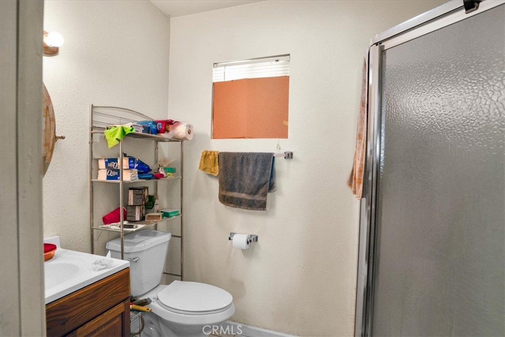 72775 2 Mile Road Twentynine Palms, CA 92277 - Photo 29 of 55 a bathroom with a toilet sink and a shower curtain