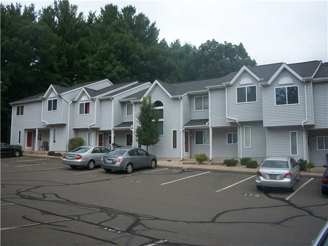 155 Redstone Hill Road, Unit 174 Bristol, CT 06010 - Photo 1 of 1 a front view of a building with lots of cars and trees