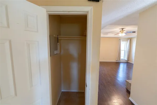 a view of a hallway with wooden floor