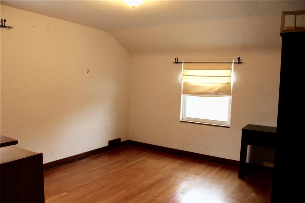 825 Geyer Road Pittsburgh, PA 15212 - Photo 12 of 20 a view of an empty room with wooden floor and a window