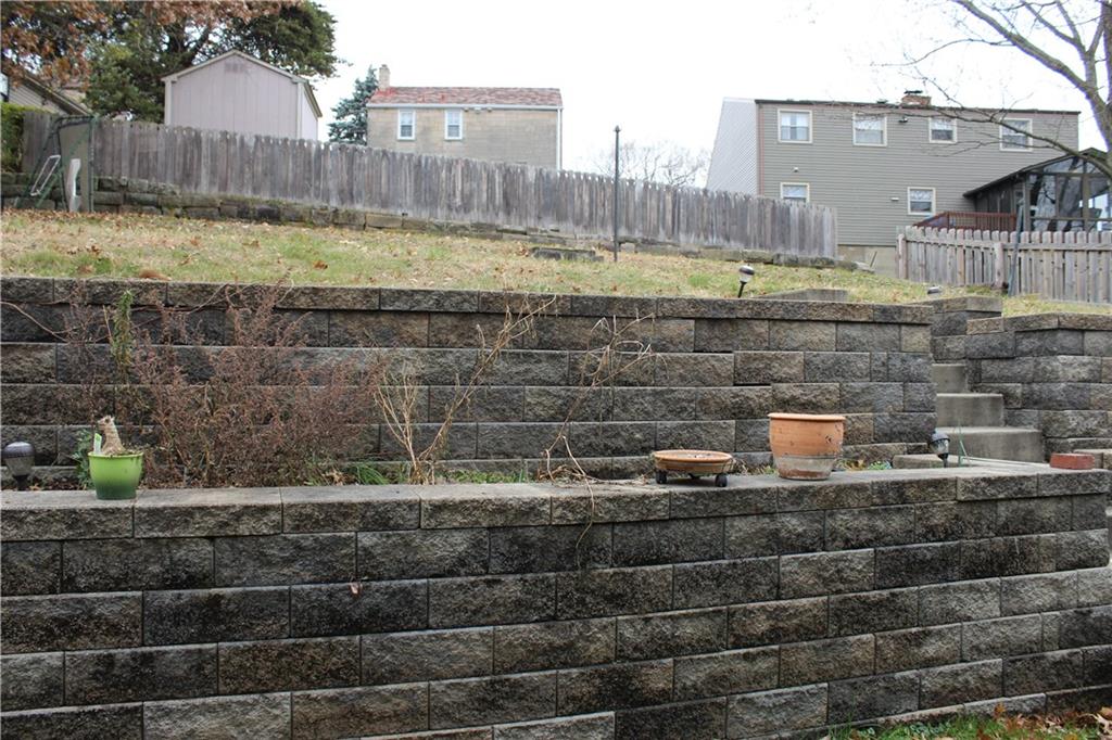 825 Geyer Road Pittsburgh, PA 15212 - Photo 18 of 20 a view of swimming pool with a yard and wooden fence