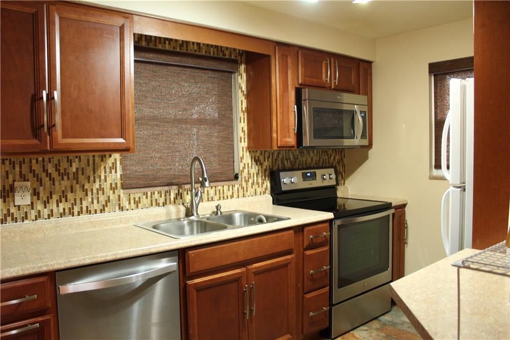 825 Geyer Road Pittsburgh, PA 15212 - Photo 4 of 20 a kitchen with stainless steel appliances granite countertop a sink stove and refrigerator
