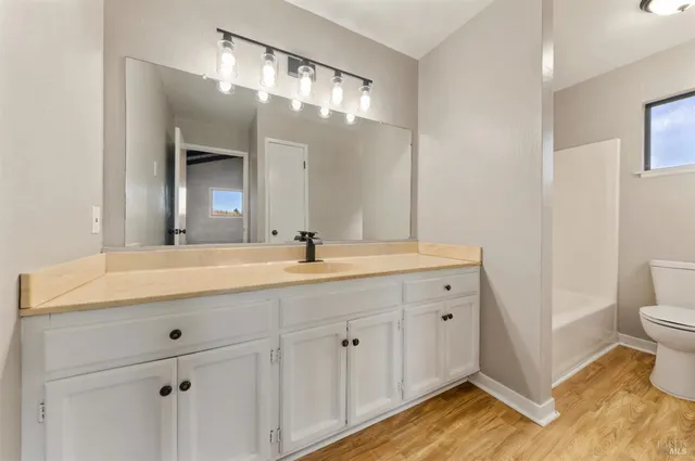 a bathroom with a double vanity sink and a mirror