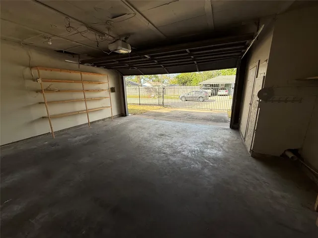a view of empty room with wooden floor and windows