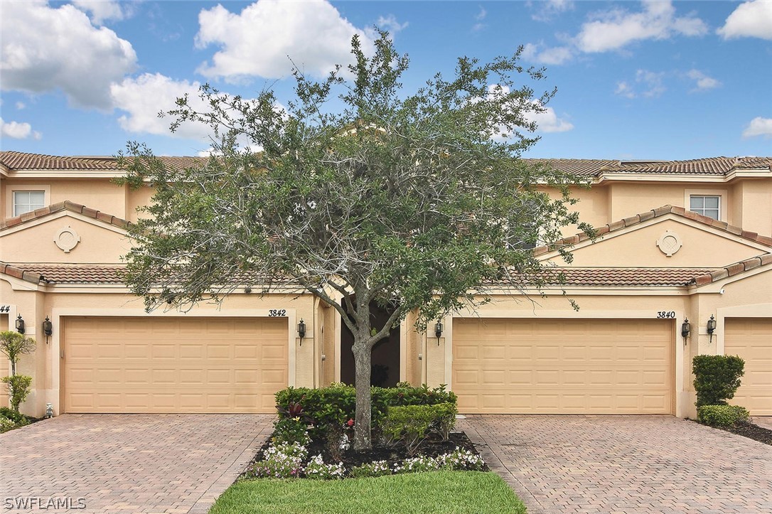 3840 Cherrybrook Loop Fort Myers, FL 33966 - Photo 1 of 32 a front view of a house with garden